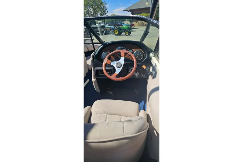 Slide: The Image of Interior view of a 2000 Calabria Sport Comp XTS boat with steering wheel and dashboard. - 14
