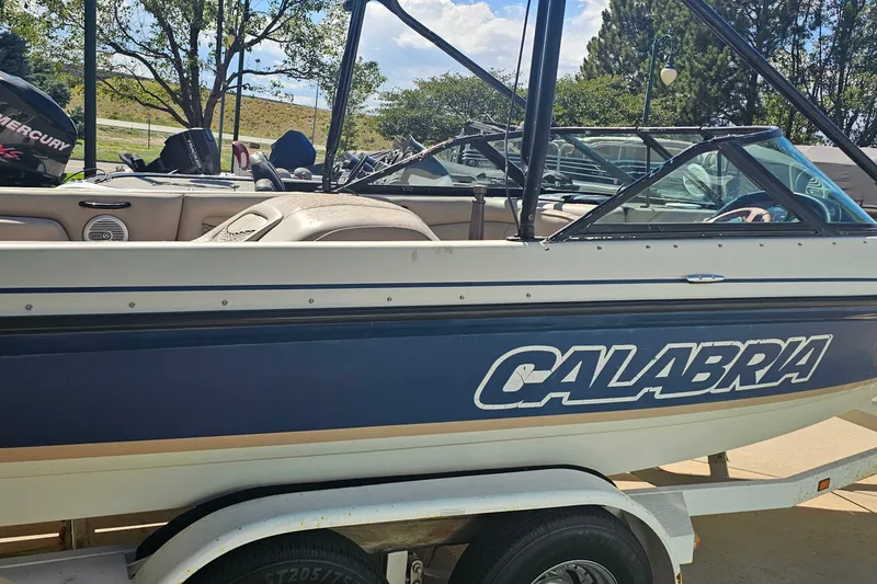 Slide: The Image of 2000 Calabria Sport Comp XTS boat on trailer, side view with visible interior. - 13