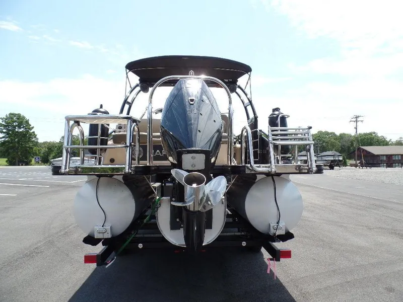 Slide: The Image of 2021 Harris Solstice 250 SL pontoon boat, rear view, parked on trailer. - 13