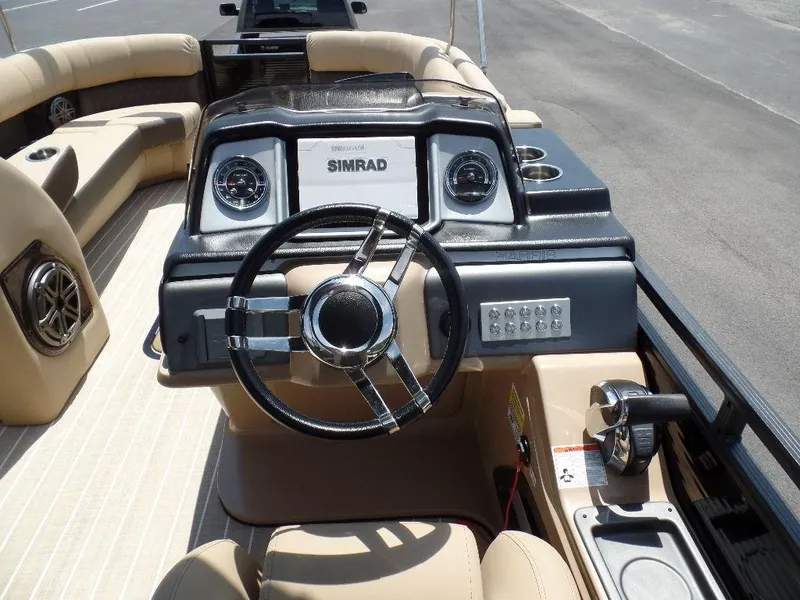 Slide: The Image of 2021 Harris Solstice 250 SL boat dashboard with steering wheel and Simrad display. - 14