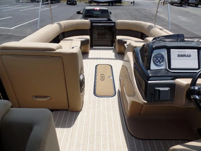 Slide: The Image of Interior of 2021 Harris Solstice 250 SL pontoon boat with beige seating and Simrad navigation. - 16