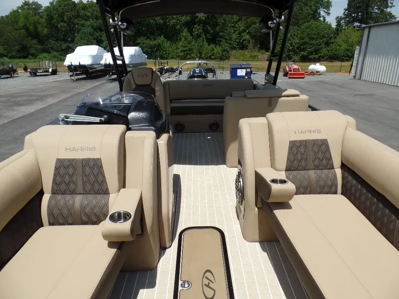 Slide: The Image of 2021 Harris Solstice 250 SL pontoon boat with luxurious beige seating and cup holders. - 5