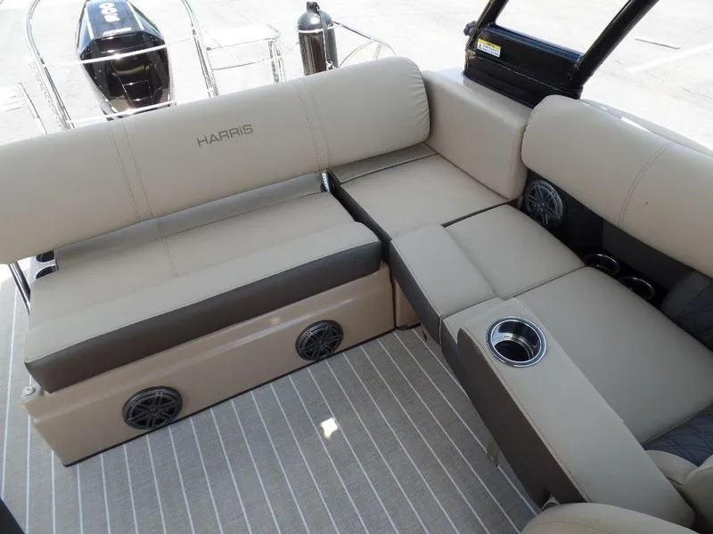 Slide: The Image of 2021 Harris Solstice 250 SL boat interior with beige seating and cup holders. - 6