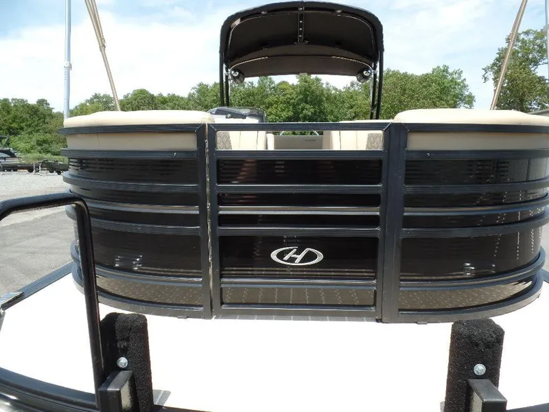 Slide: The Image of 2021 Harris Solstice 250 SL pontoon boat, black exterior, docked outdoors. - 7