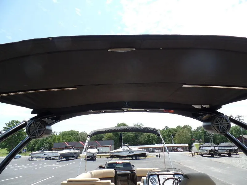 Slide: The Image of 2021 Harris Solstice 250 SL boat with canopy, parked in a marina lot. - 8