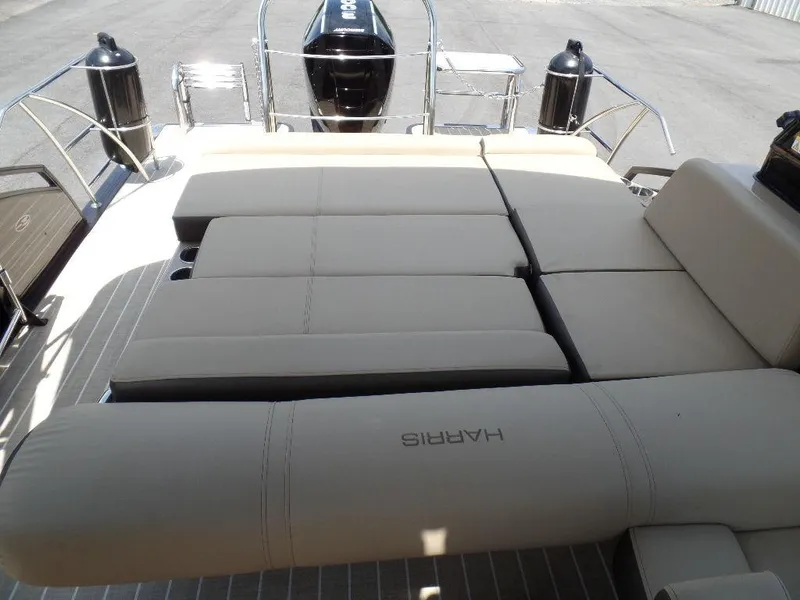Slide: The Image of 2021 Harris Solstice 250 SL boat with spacious beige seating and sleek design. - 9