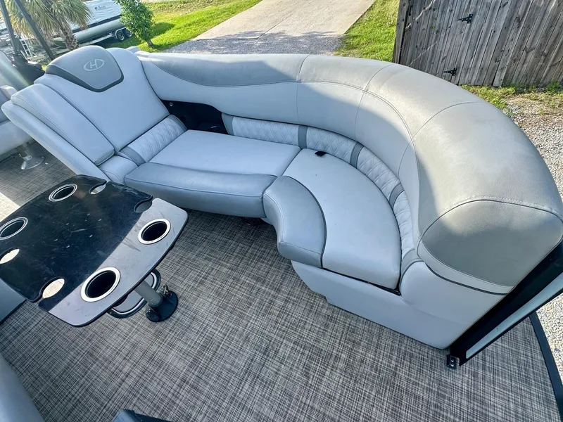 Slide: The Image of Luxurious seating on 2021 Harris Grand Mariner 250 pontoon boat with cupholders and table. - 12