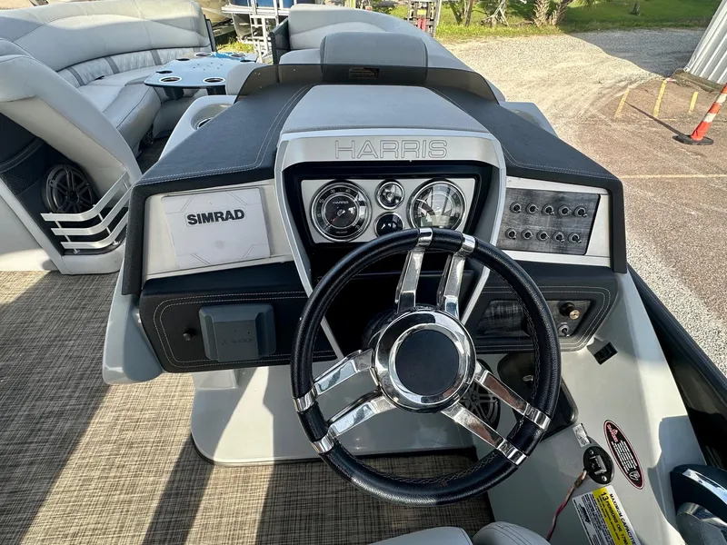 Slide: The Image of 2021 Harris Grand Mariner 250 dashboard with steering wheel and control panel. - 15