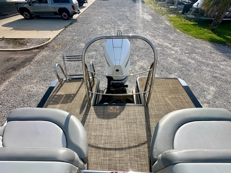 Slide: The Image of 2021 Harris Grand Mariner 250 pontoon boat with rear seating and outboard motor. - 21