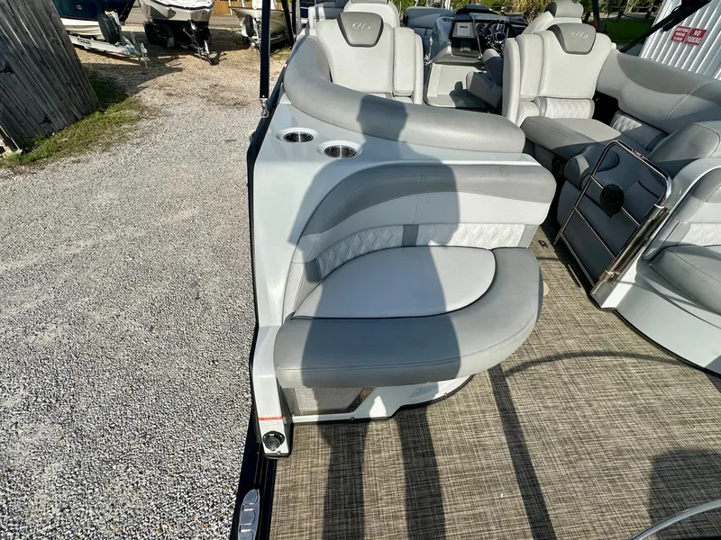 Slide: The Image of 2021 Harris Grand Mariner 250 boat interior with plush gray seating and cup holders. - 23
