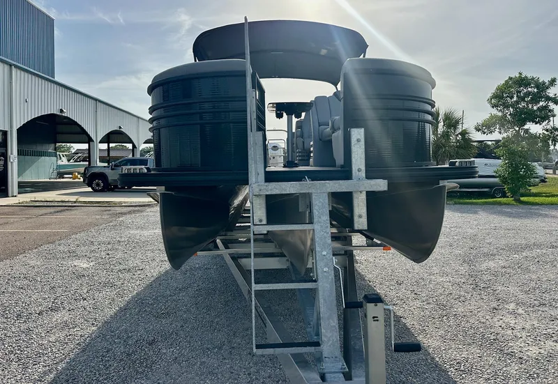 Slide: The Image of 2021 Harris Grand Mariner 250 pontoon boat on trailer, parked outdoors under sunlight. - 8