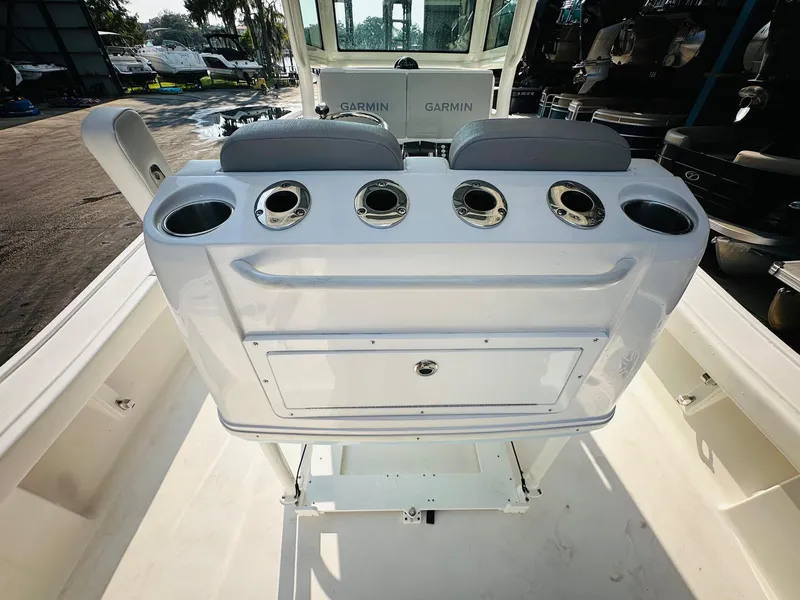 Slide: The Image of 2024 Caymas 281 HB boat interior with rod holders and storage compartment. - 16