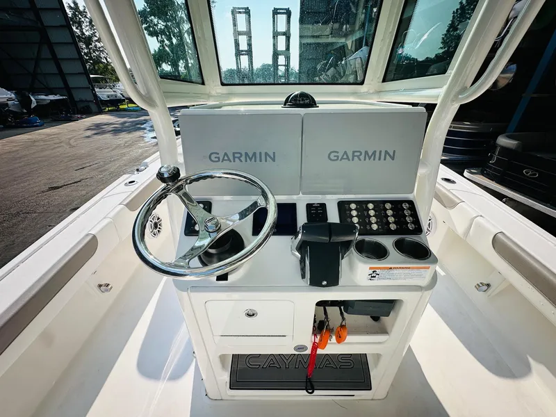Slide: The Image of 2024 Caymas 281 HB boat helm with dual Garmin displays and steering wheel. - 17
