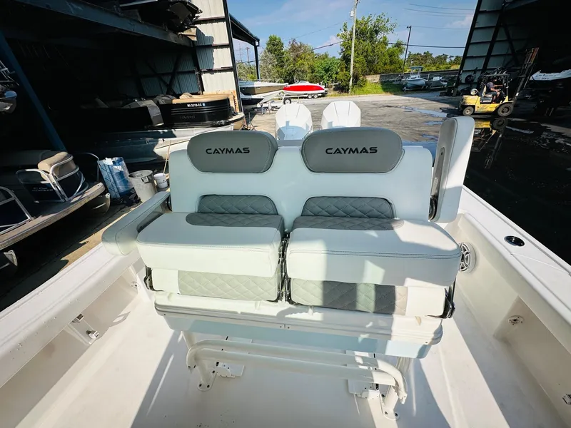 Slide: The Image of 2024 Caymas 281 HB boat interior with cushioned seating and storage compartments. - 18