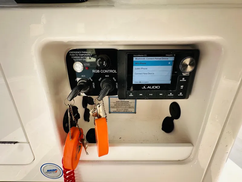 Slide: The Image of 2024 Caymas 281 HB boat dashboard with JL Audio system and RGB control panel. - 20