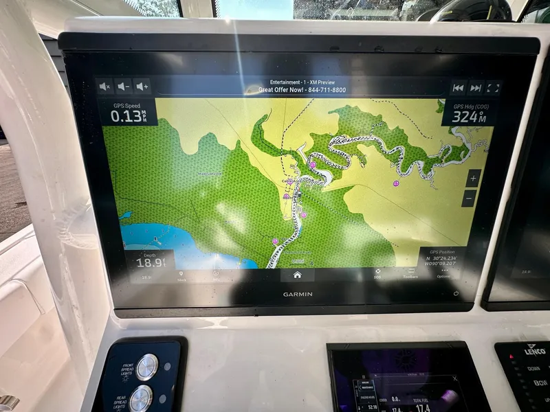 Slide: The Image of 2024 Caymas 281 HB boat with Garmin navigation display showing a detailed map. - 25