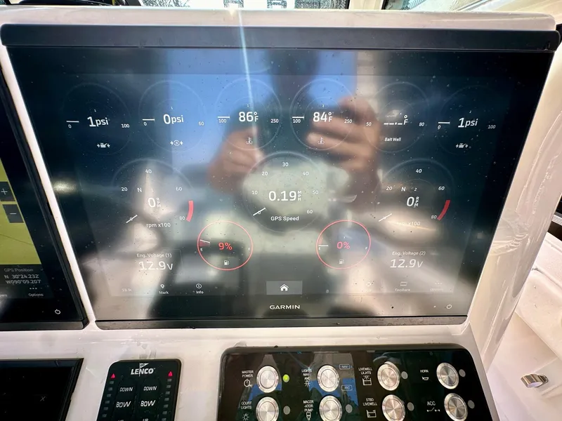 Slide: The Image of 2024 Caymas 281 HB boat dashboard with Garmin display showing engine metrics and controls. - 26
