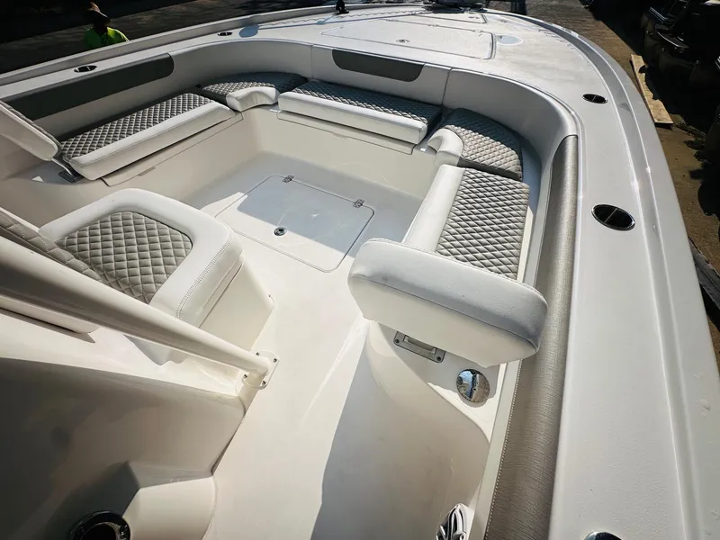 Slide: The Image of 2024 Caymas 281 HB boat interior with cushioned seating and sleek design. - 28