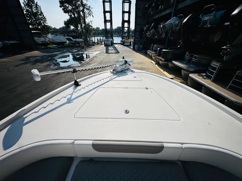 Slide: The Image of 2024 Caymas 281 HB boat deck with trolling motor in marina setting. - 29