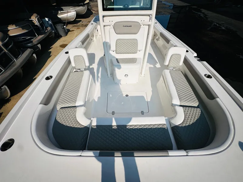 Slide: The Image of 2024 Caymas 281 HB boat interior with cushioned seating and storage compartments. - 30