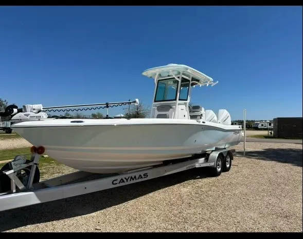 Slide: The Image of 2024 Caymas 281 HB boat on trailer under clear blue sky. - 33