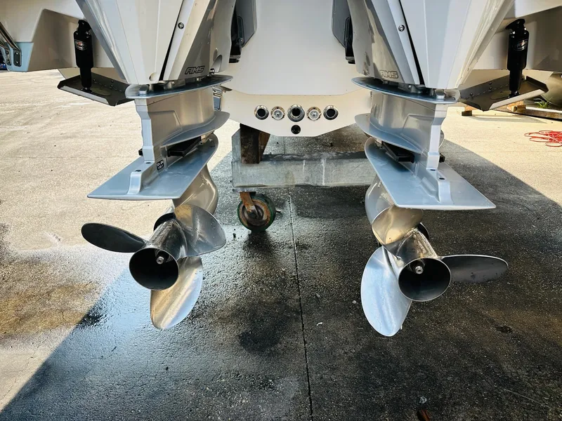 Slide: The Image of 2024 Caymas 281 HB boat with dual outboard propellers on a wet dock surface. - 9