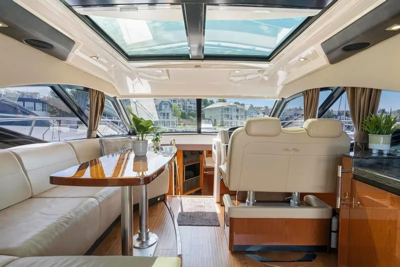 Slide: The Image of Luxurious interior of 2015 Sea Ray 510 Sundancer yacht with panoramic windows and elegant seating. - 12