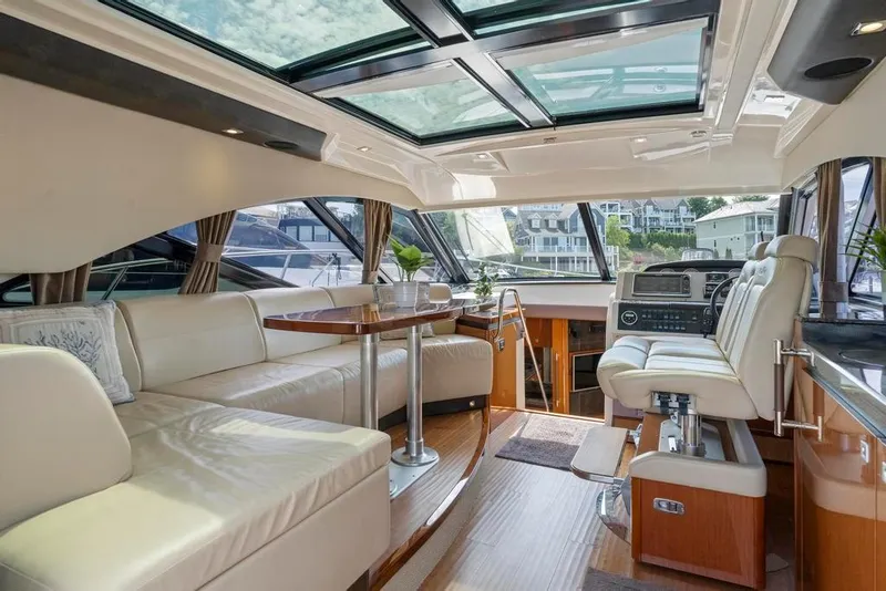 Slide: The Image of Luxurious interior of 2015 Sea Ray 510 Sundancer yacht with leather seating and panoramic windows. - 14