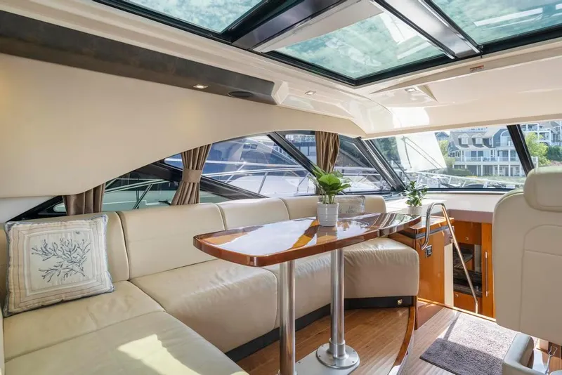 Slide: The Image of Luxurious interior of 2015 Sea Ray 510 Sundancer yacht with elegant seating and skylight. - 15