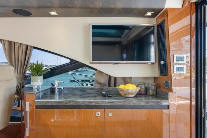 Slide: The Image of Luxurious interior of 2015 Sea Ray 510 Sundancer yacht with TV and kitchenette. - 16