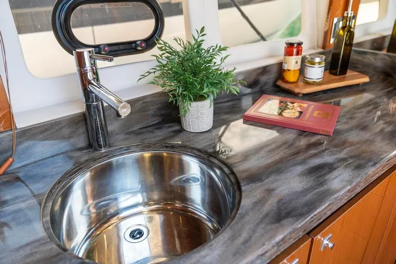 Slide: The Image of Luxurious kitchen sink area in 2015 Sea Ray 510 Sundancer yacht with modern fixtures. - 17