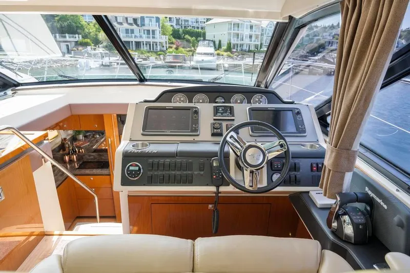 Slide: The Image of 2015 Sea Ray 510 Sundancer helm with modern controls and luxurious interior. - 18