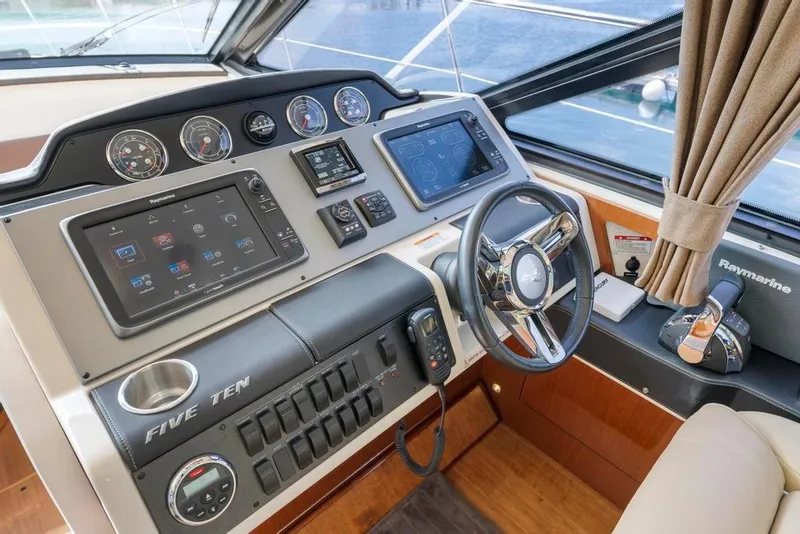 Slide: The Image of 2015 Sea Ray 510 Sundancer helm with advanced navigation controls and luxurious interior. - 19