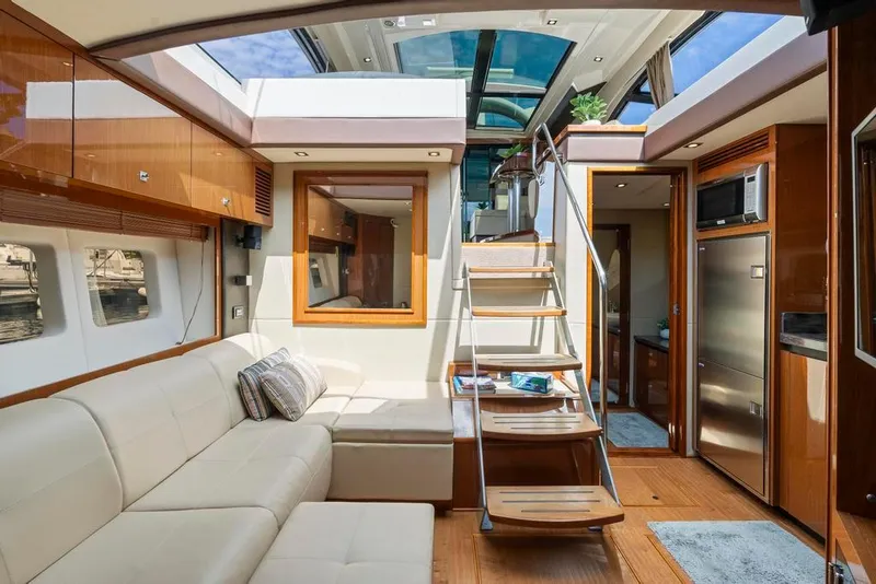 Slide: The Image of Luxurious interior of 2015 Sea Ray 510 Sundancer yacht with modern furnishings and skylight. - 23