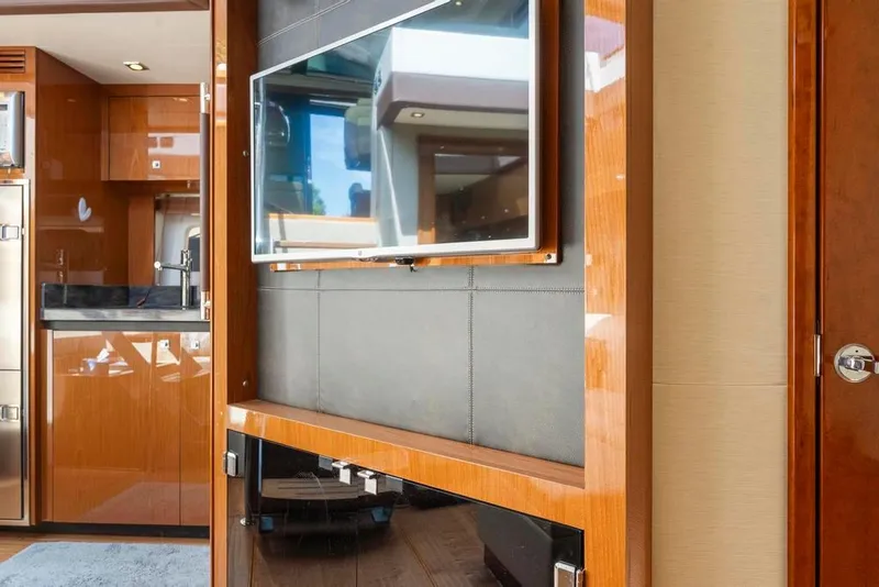 Slide: The Image of Luxurious interior of 2015 Sea Ray 510 Sundancer yacht with modern TV and wood finish. - 26