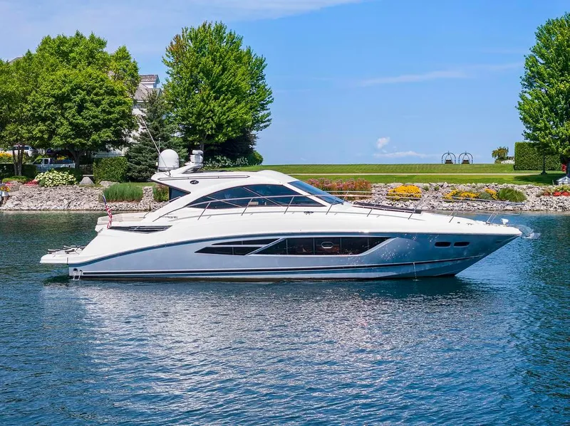 Slide: The Image of 2015 Sea Ray 510 Sundancer yacht on a serene lake with lush greenery. - 3