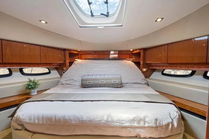 Slide: The Image of Luxurious bedroom interior of 2015 Sea Ray 510 Sundancer yacht with skylight and wood accents. - 32