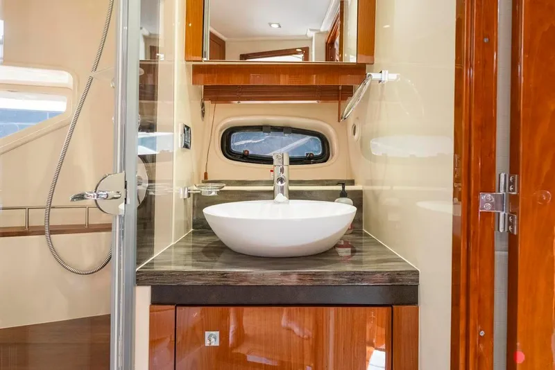 Slide: The Image of Luxurious bathroom interior of 2015 Sea Ray 510 Sundancer yacht with modern sink and wood finish. - 34