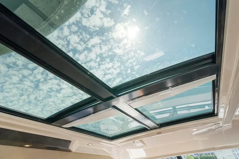 Slide: The Image of Skylight view from 2015 Sea Ray 510 Sundancer, showcasing clear sky and sunlight. - 8