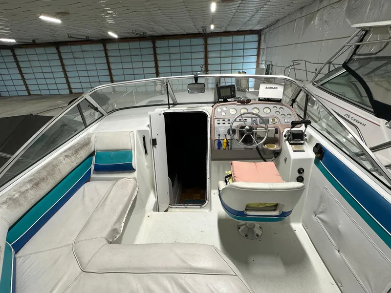 Slide: The Image of 1993 Rinker 280 Fiesta Vee boat interior with helm, seating, and navigation equipment. - 10
