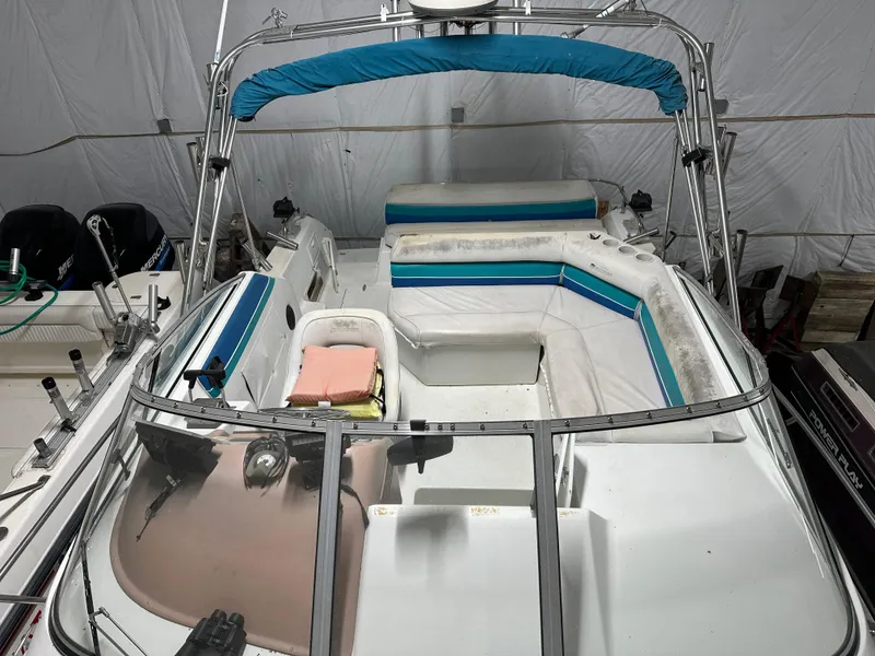 Slide: The Image of 1993 Rinker 280 Fiesta Vee boat interior with seating and canopy in storage. - 11