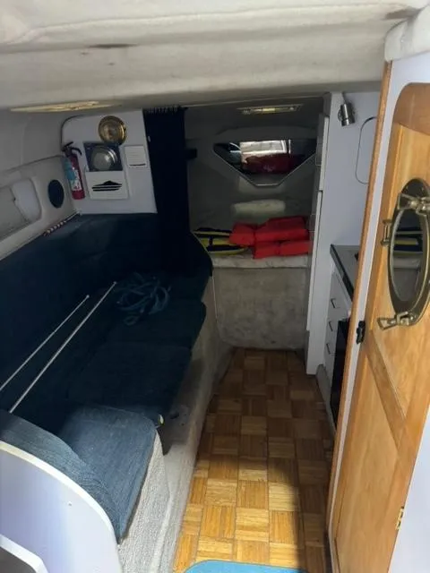 Slide: The Image of Interior of 1993 Rinker 280 Fiesta Vee boat with seating and cabin amenities. - 22