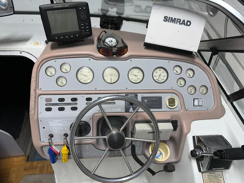 Slide: The Image of 1993 Rinker 280 Fiesta Vee boat dashboard with steering wheel, gauges, and navigation equipment. - 30