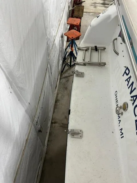 Slide: The Image of 1993 Rinker 280 Fiesta Vee boat docked, showing stern and ladder, Onekama, MI. - 6