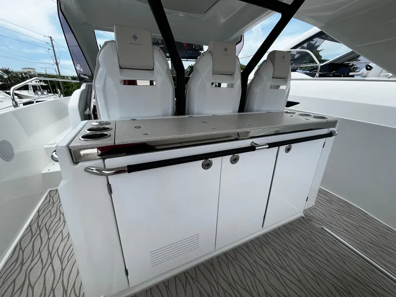 Slide: The Image of 2024 Jeanneau DB37 yacht interior with sleek seating and modern cabinetry. - 10