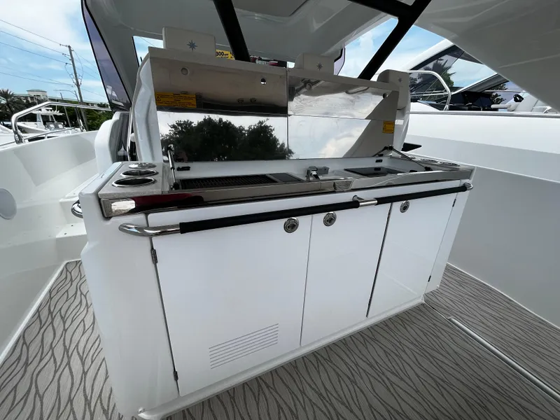Slide: The Image of 2024 Jeanneau DB37 boat with sleek outdoor kitchen and modern design. - 11