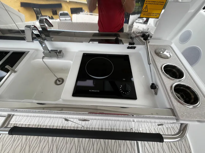 Slide: The Image of 2024 Jeanneau DB37 yacht kitchen with sink, induction cooktop, and cup holders. - 14