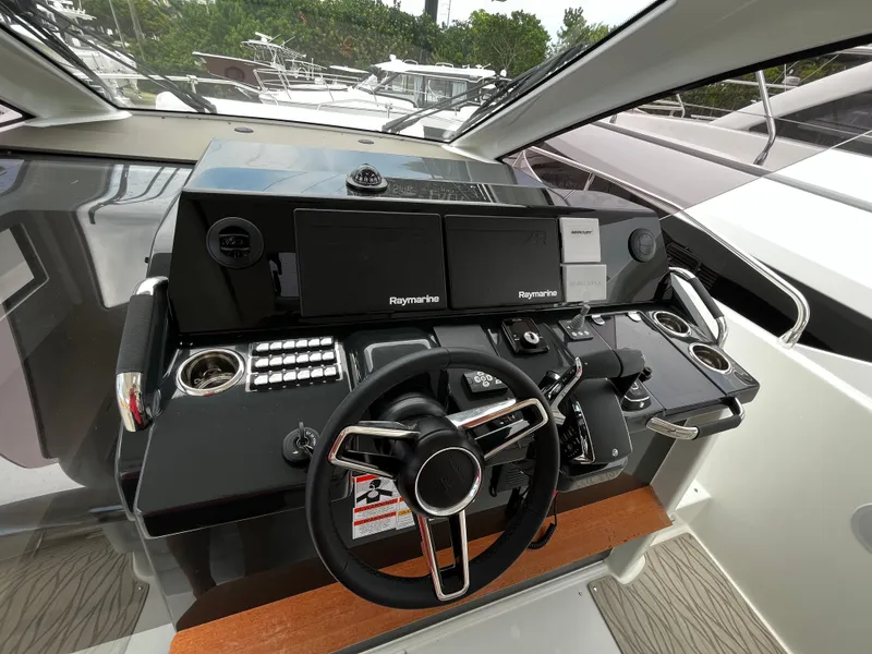 Slide: The Image of 2024 Jeanneau DB37 helm with modern controls and dual Raymarine displays. - 17