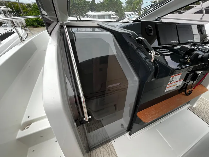 Slide: The Image of 2024 Jeanneau DB37 boat cockpit with modern controls and sleek design. - 18