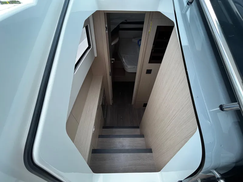 Slide: The Image of 2024 Jeanneau DB37 interior view with stairs leading to cabin area. - 19
